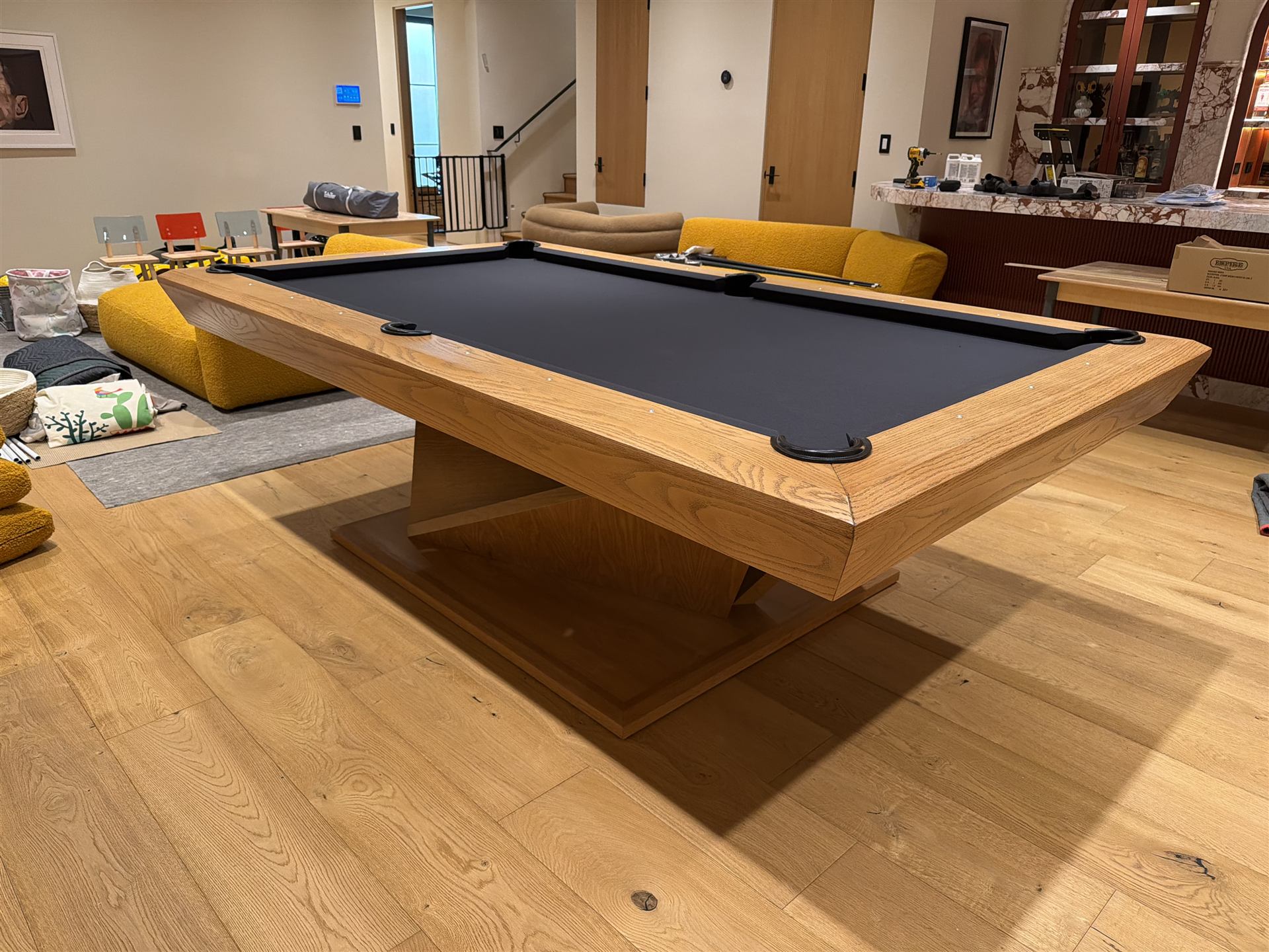 Cue sticks and accessories beside a pool table