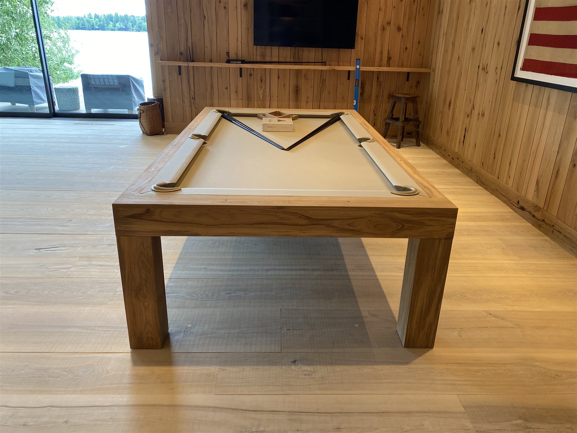 Solid wood pool table in a lakeside living space